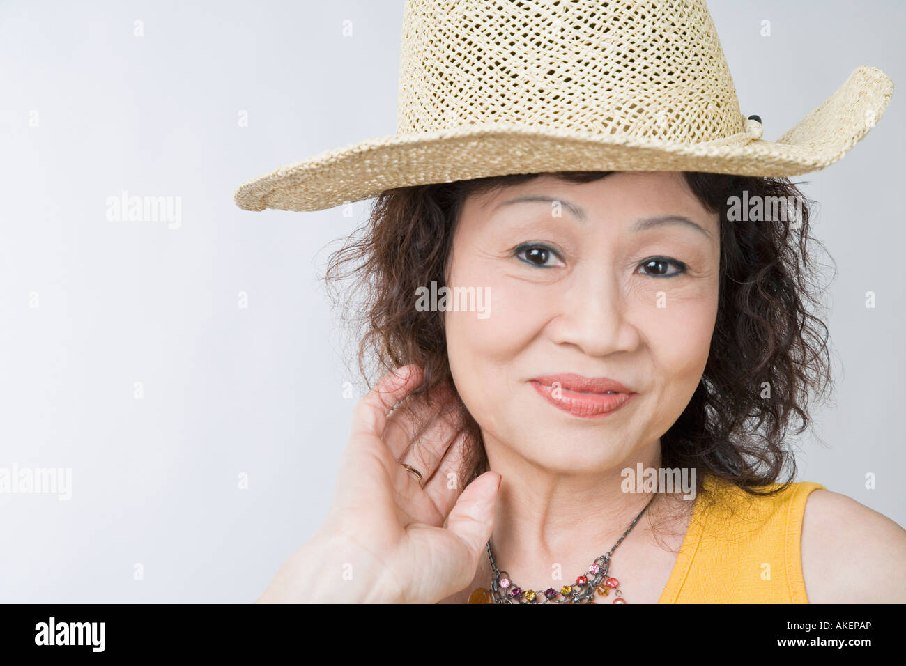 Portrait of a senior woman wearing a straw hat and posing Stock Photo ...