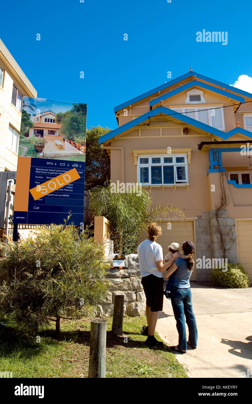 A family standing outside their new home Stock Photo - Alamy