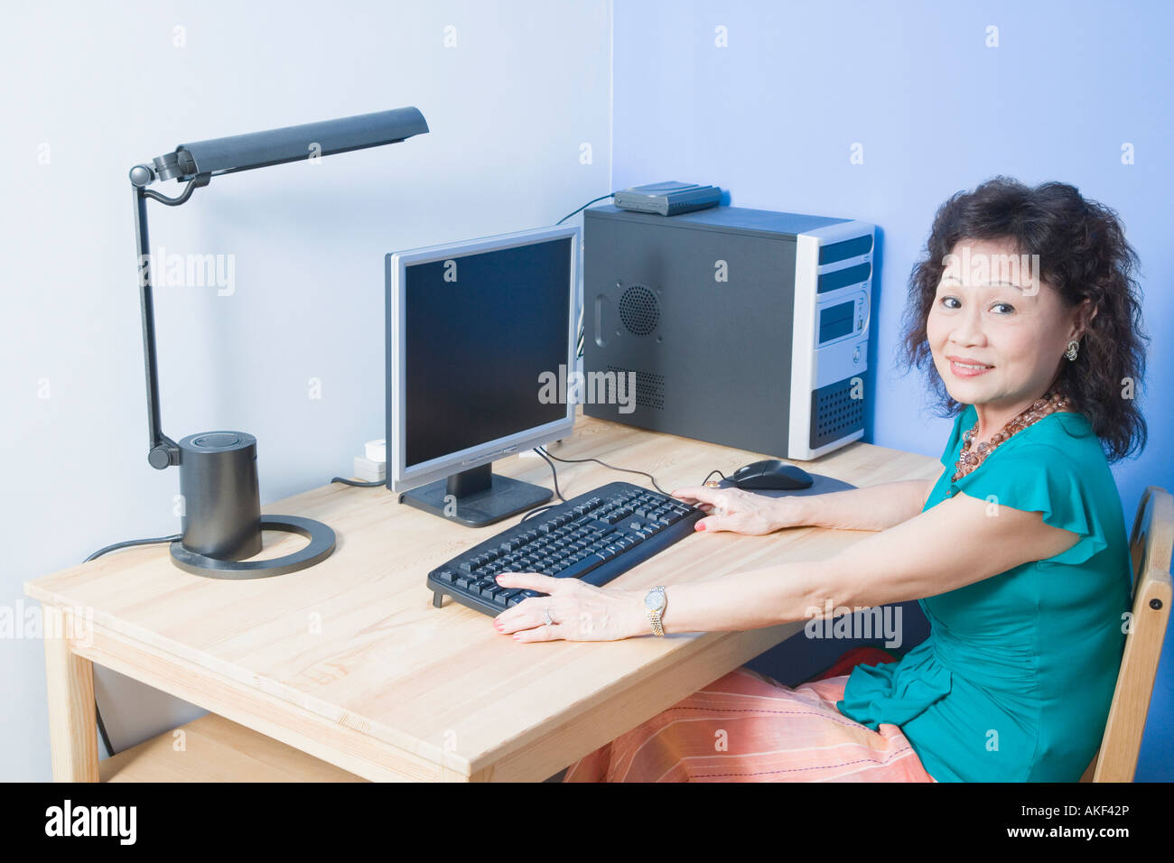 Portrait of a senior woman using a computer and smiling Stock Photo