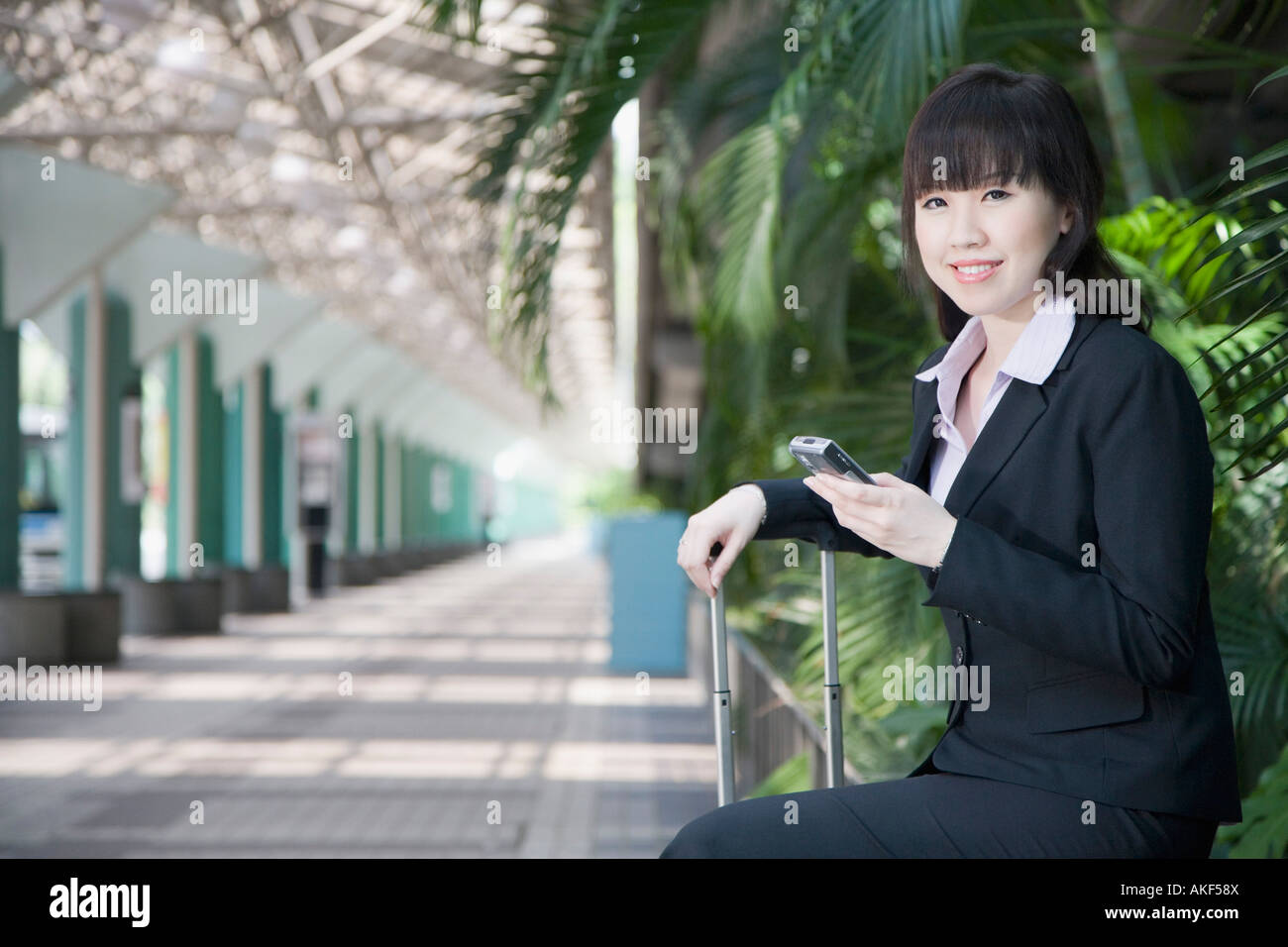 Side profile of a businesswoman and holding a mobile phone Stock Photo