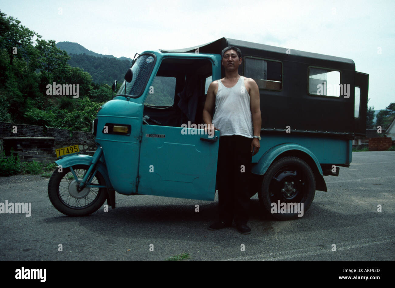 Chinese Tricycle Driver near the Great Wall China Stock Photo