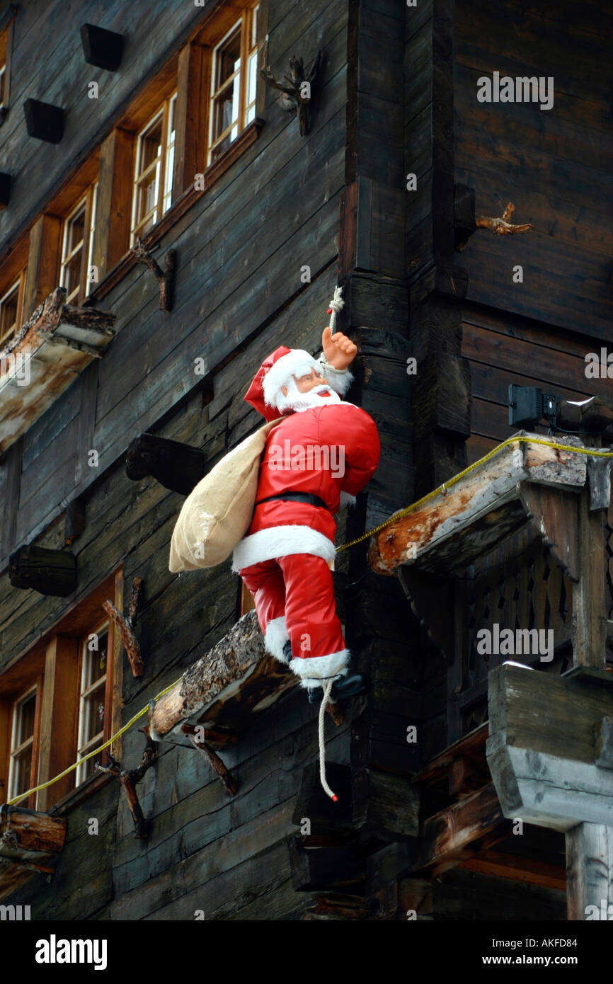 switzerland valais grimentz val d anniviers traditional father christmas model on side of wooden house Stock Photo
