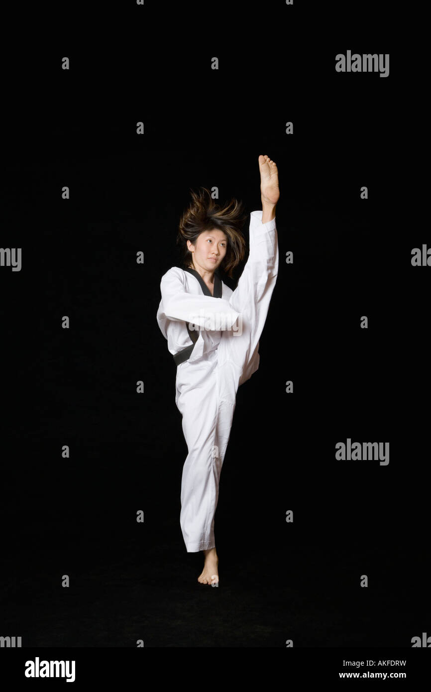 Young woman performing front kick Stock Photo - Alamy