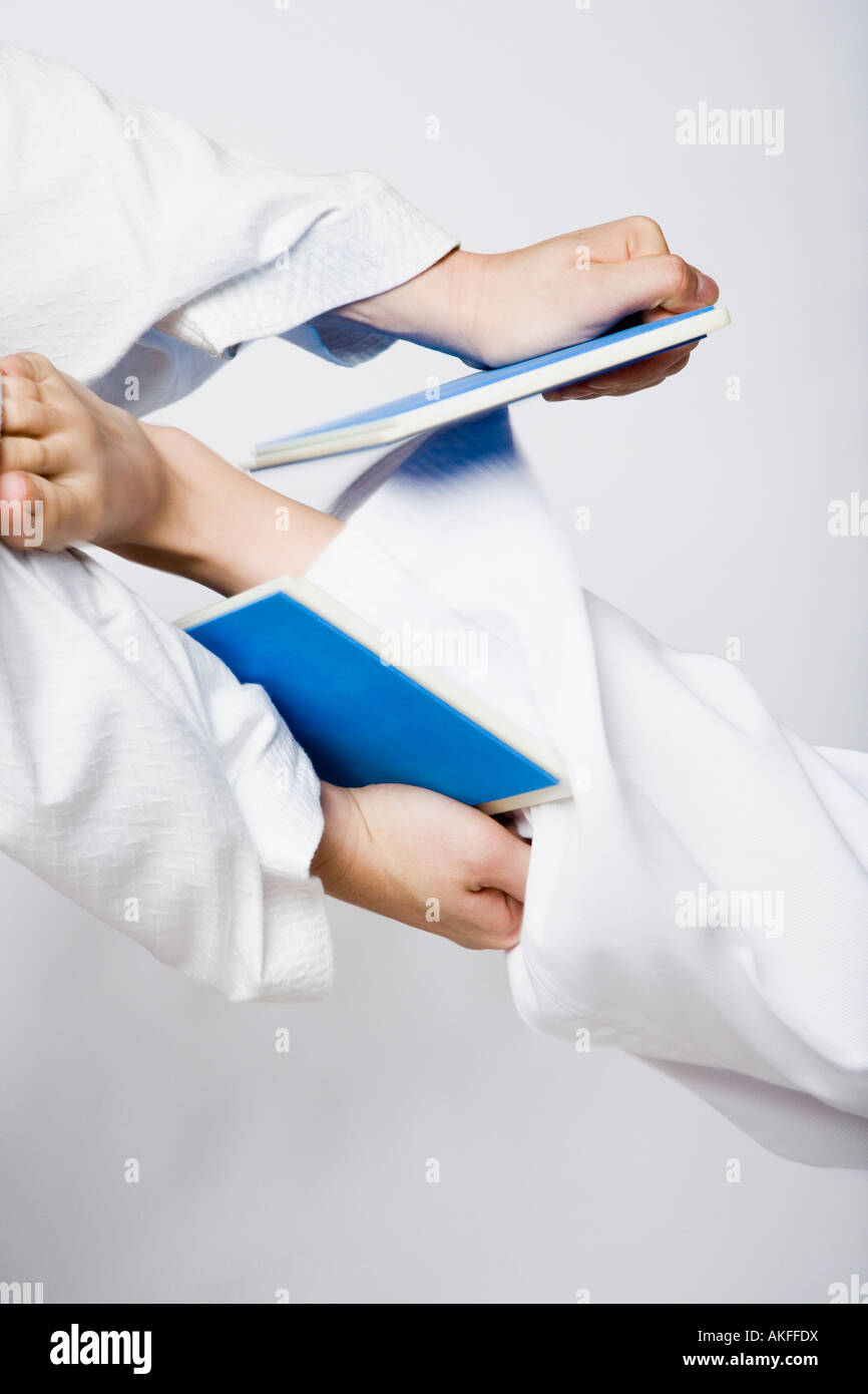 Close-up of a person's leg breaking a tile Stock Photo