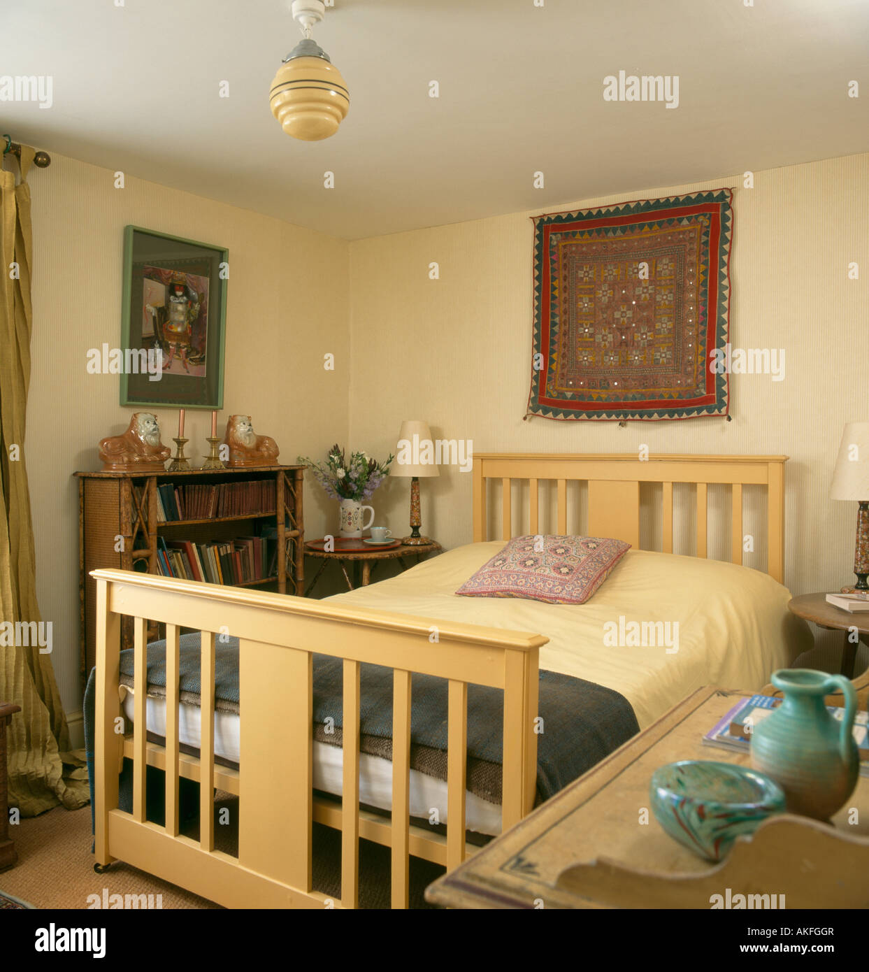 Mirrored Indian Tapestry Above Pale Wood Bed In Neutral