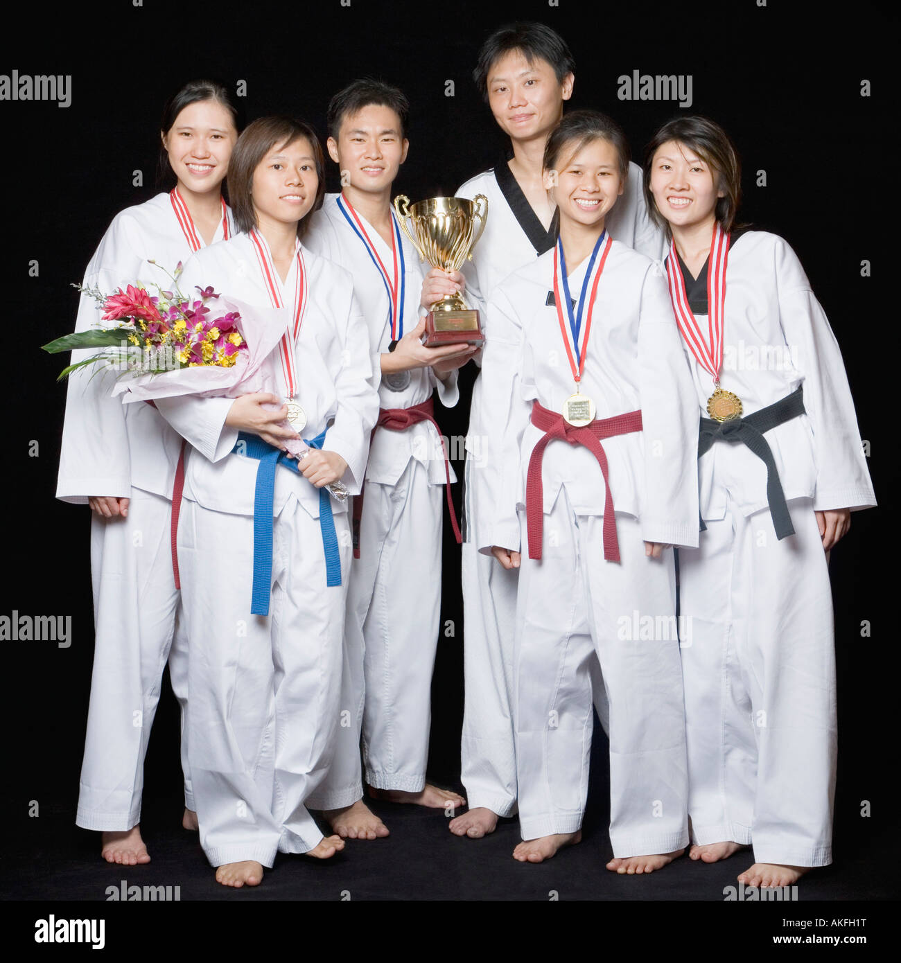 Group of martial arts players standing with their medals and trophies Stock Photo