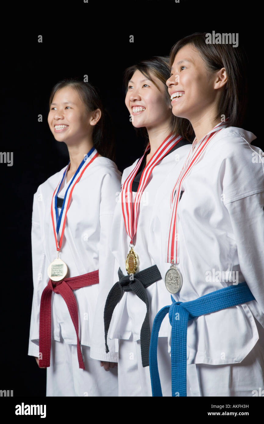 Three young women standing with their medals and smiling Stock Photo
