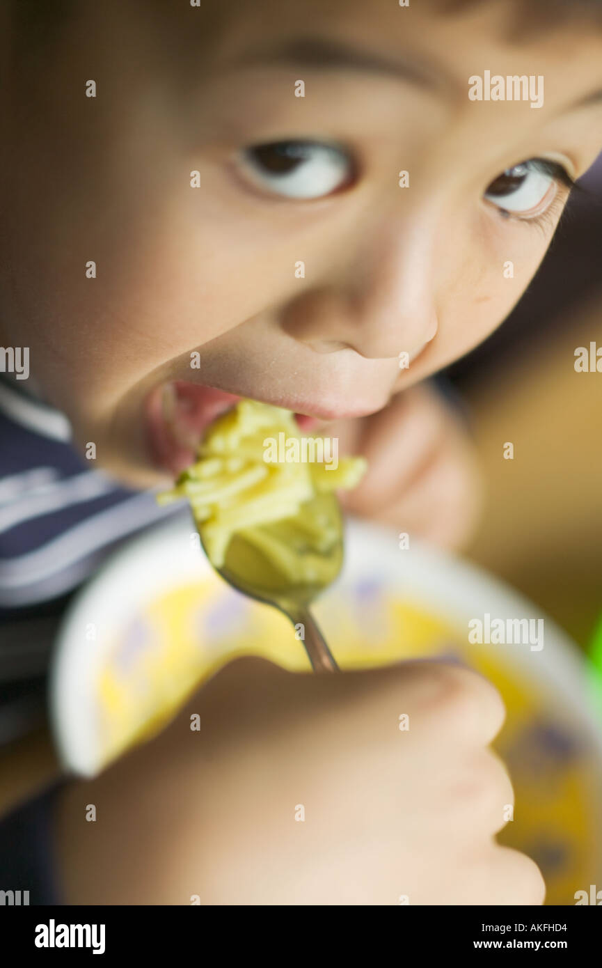 6 year old Asian boy eating Stock Photo Alamy