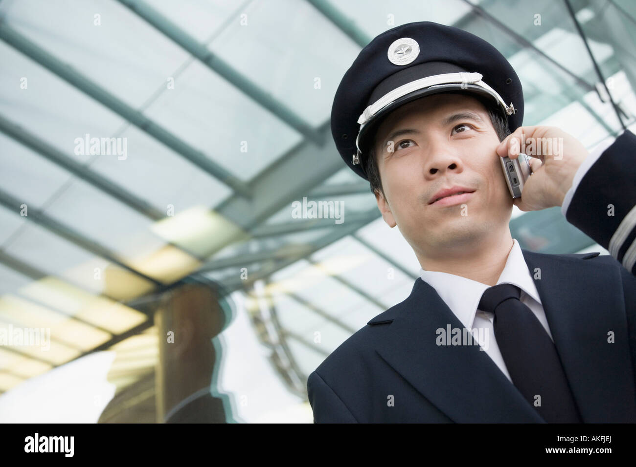Close-up of a pilot talking on a mobile phone Stock Photo