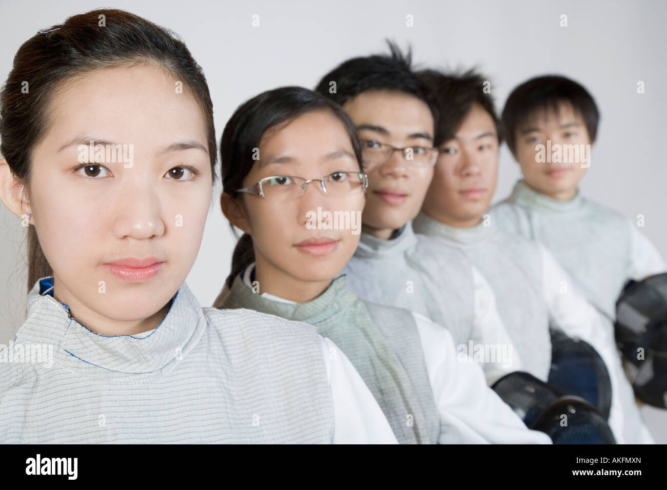 Portrait of two young women and three young men in a row Stock Photo ...
