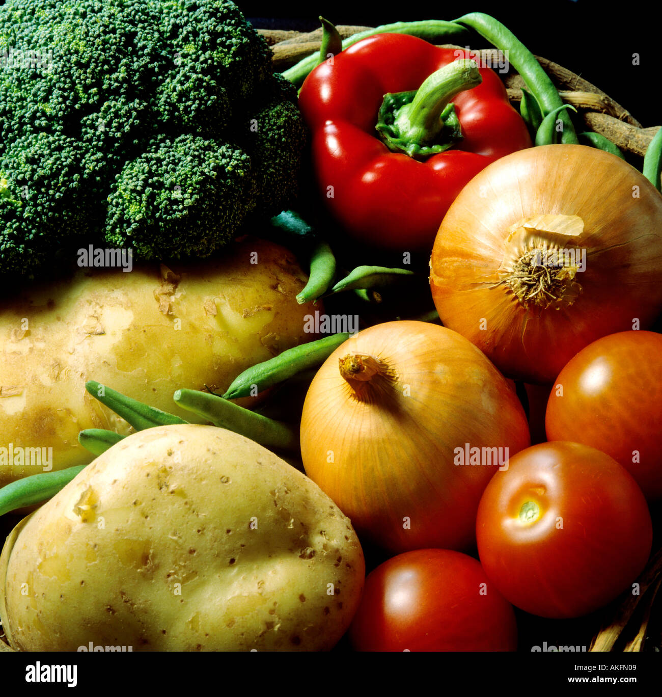 various vegetables in basket tomato onions sweet jalapeno broccoli potatoes beans Stock Photo