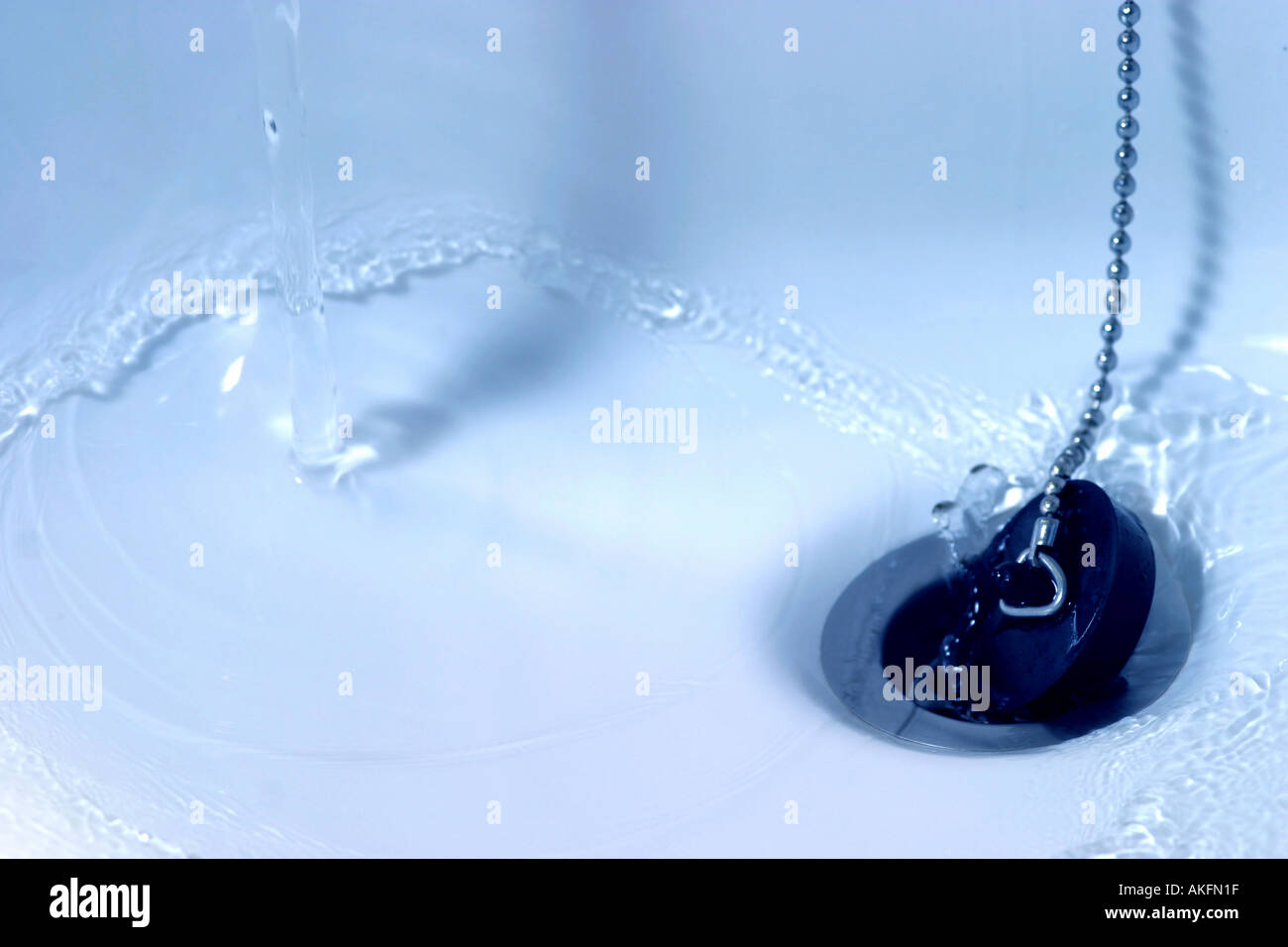 Water draining down plug or sink hole Stock Photo