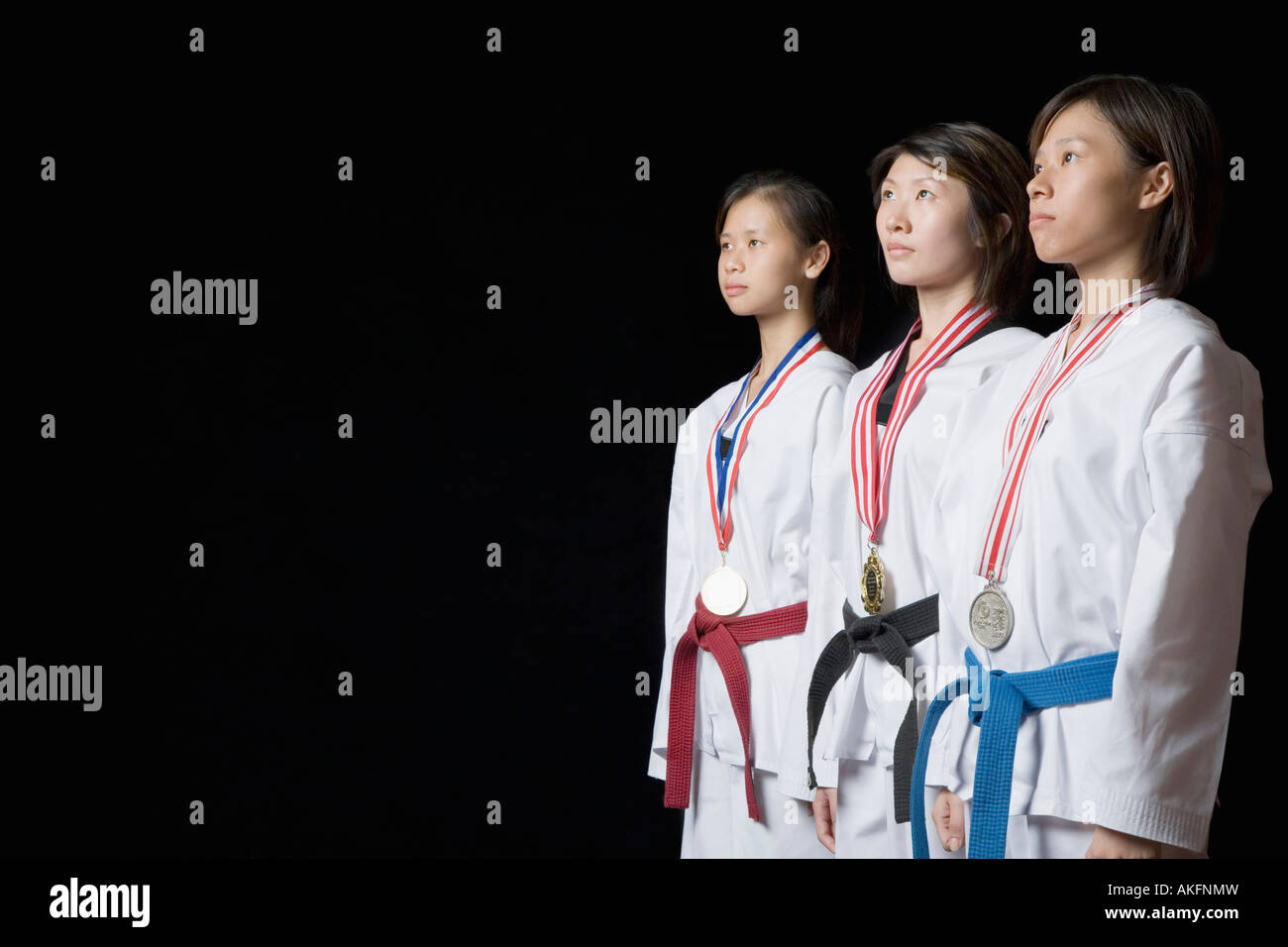 Three young women standing with their medals Stock Photo