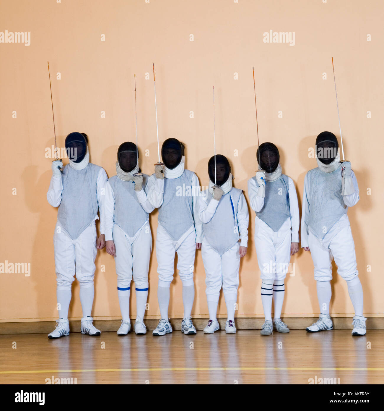 Group of people in fencing costume standing side by side Stock Photo