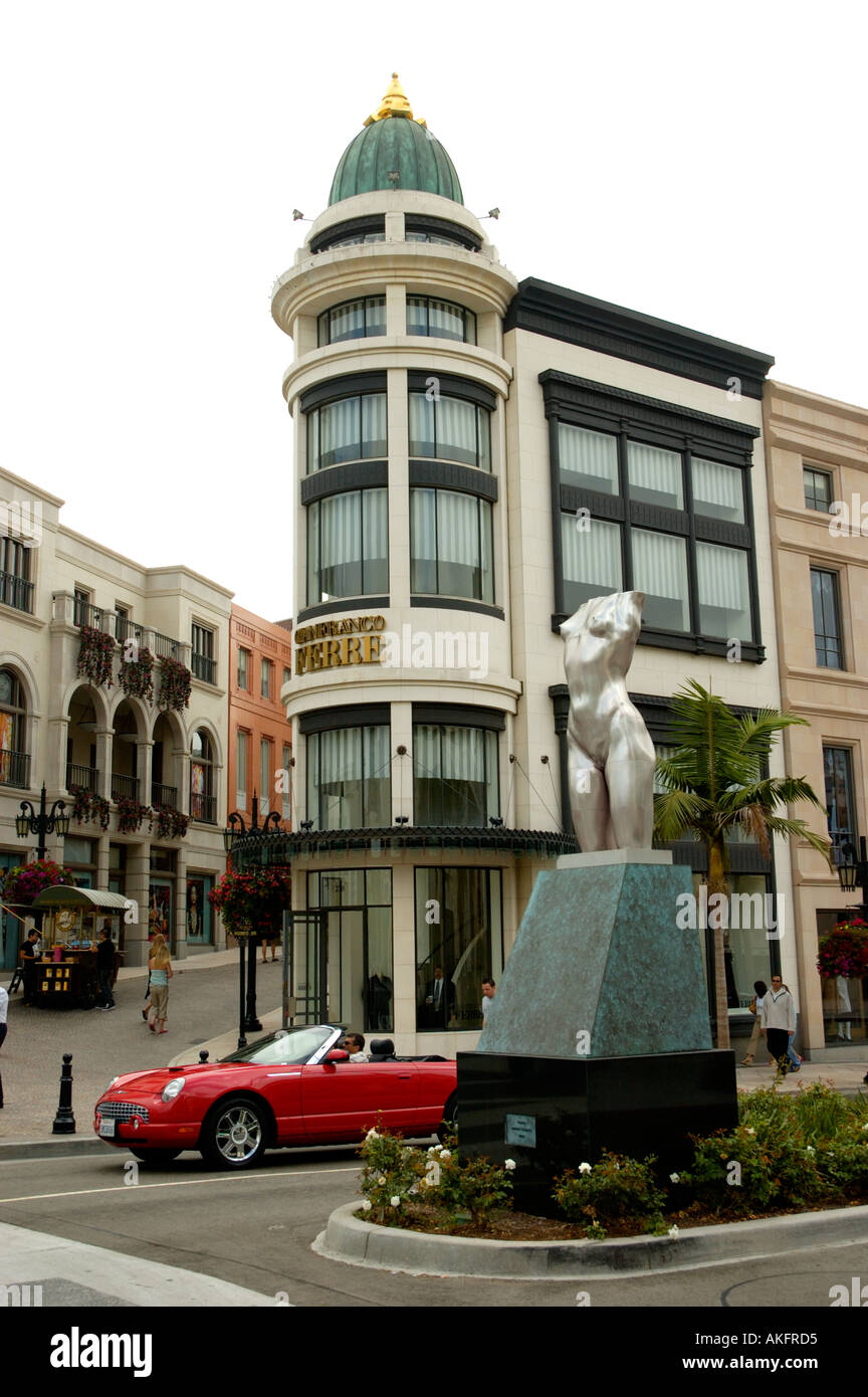 Red Ford Thunderbird convertible driving by intersection of Rodeo Drive ...
