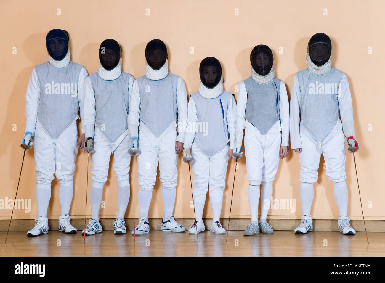 Group of people in fencing costume standing side by side Stock Photo