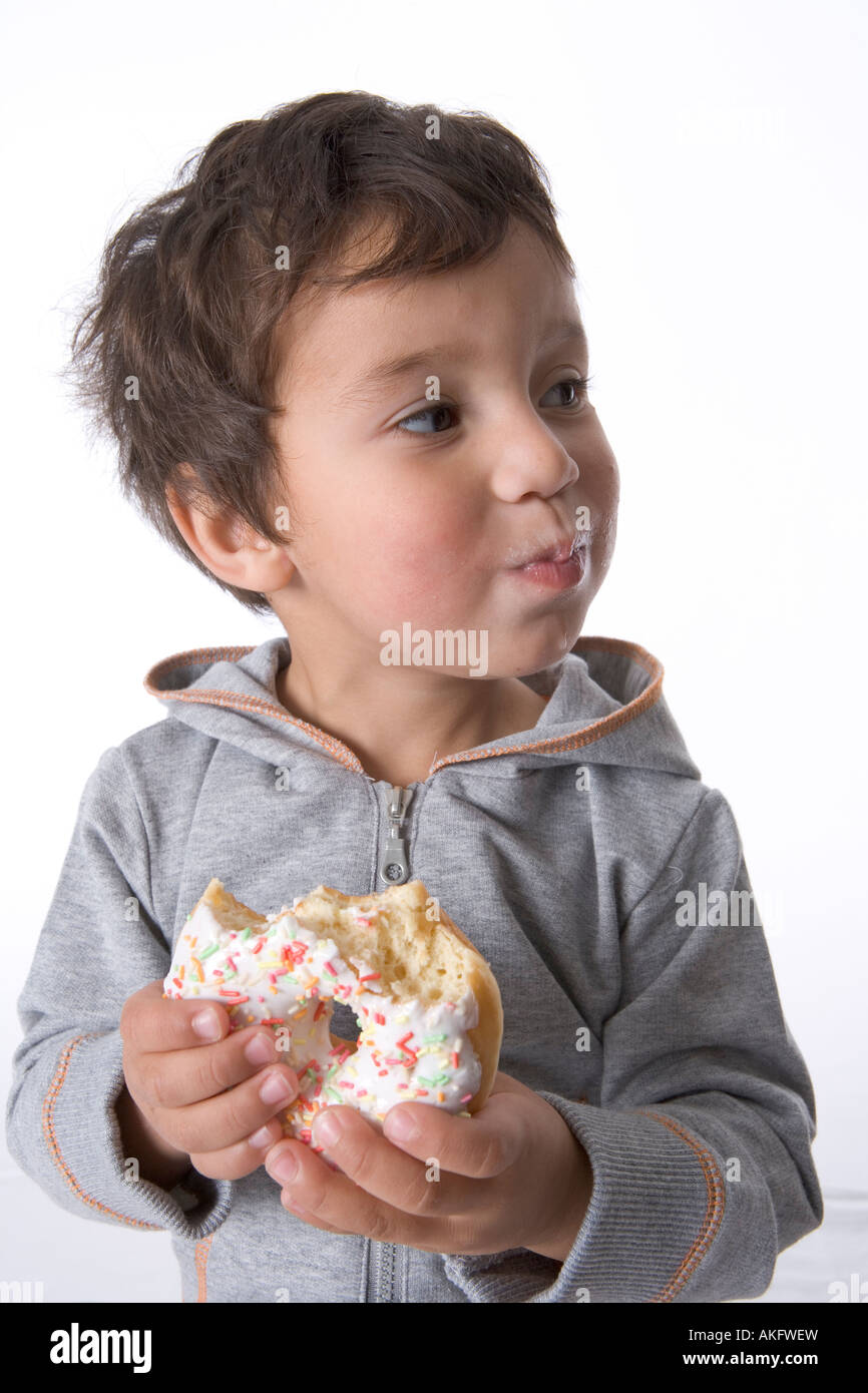 Little boy eating a donut Stock Photo