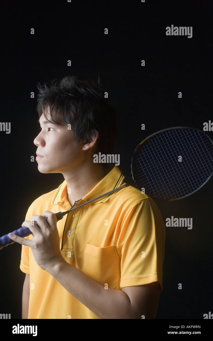 Closeup of a young man holding a badminton racket Stock Photo Alamy
