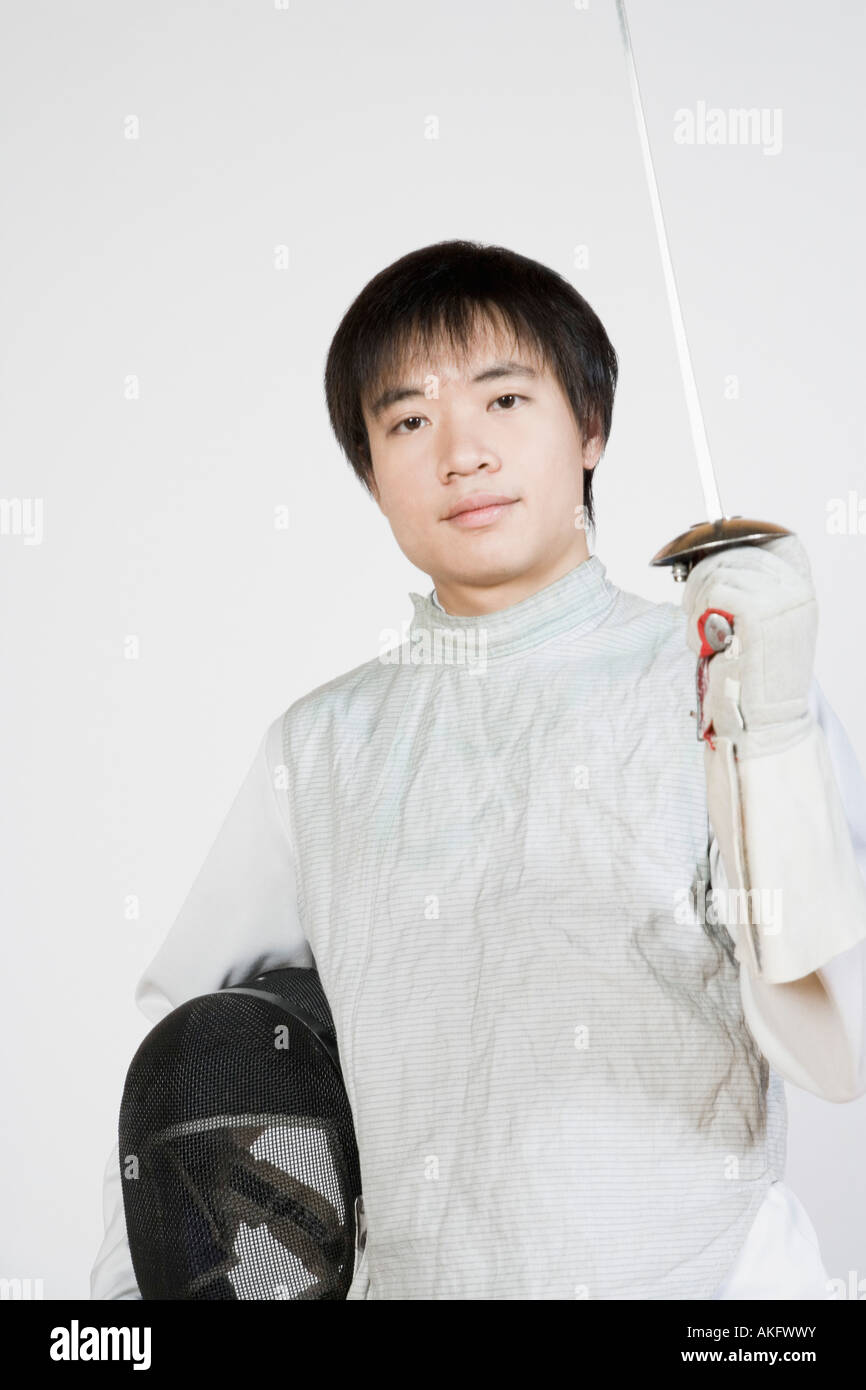 Portrait of a female fencer holding a fencing foil and a fencing mask