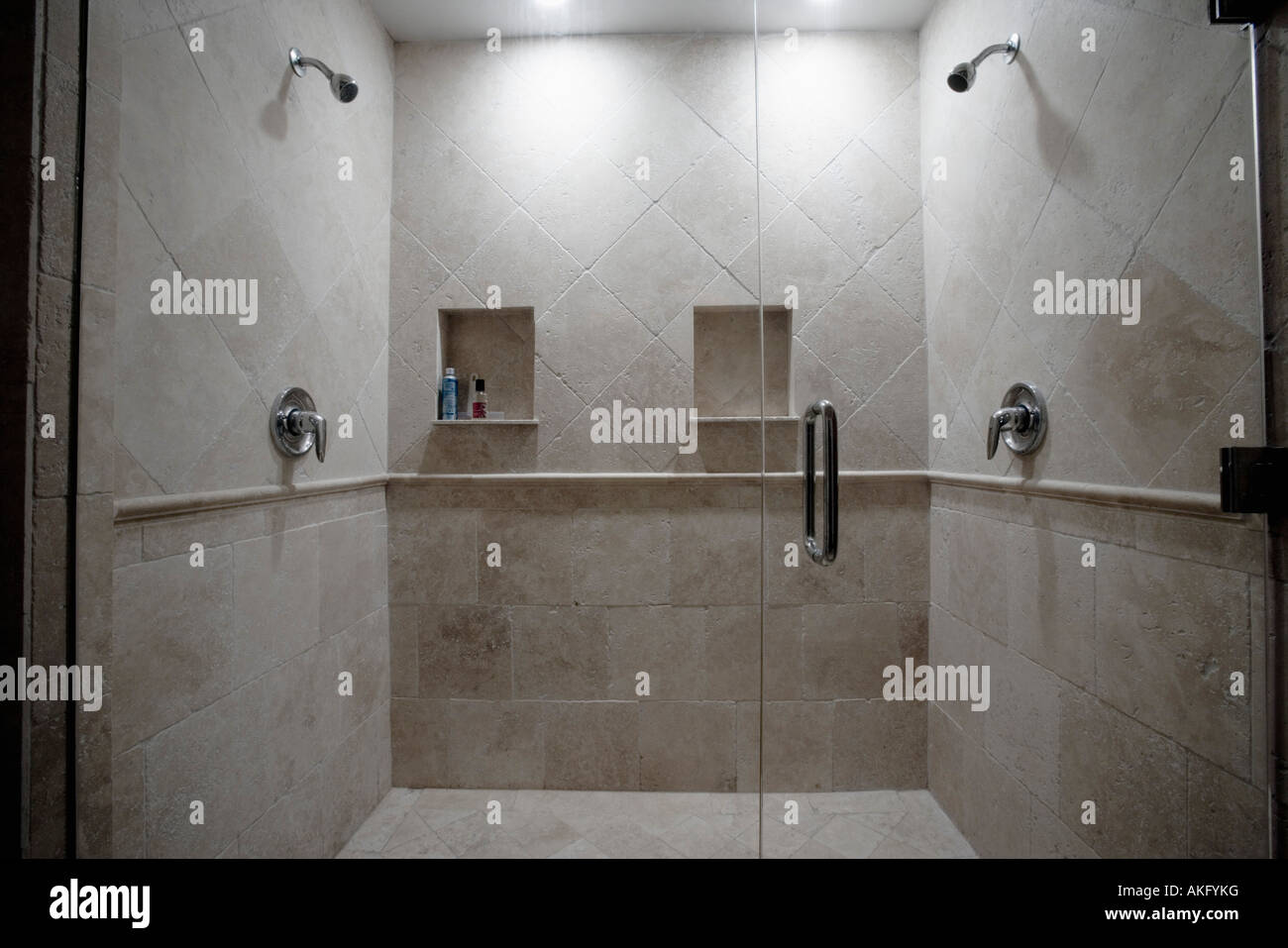 Detail of dual stone showers with glass door Stock Photo Alamy