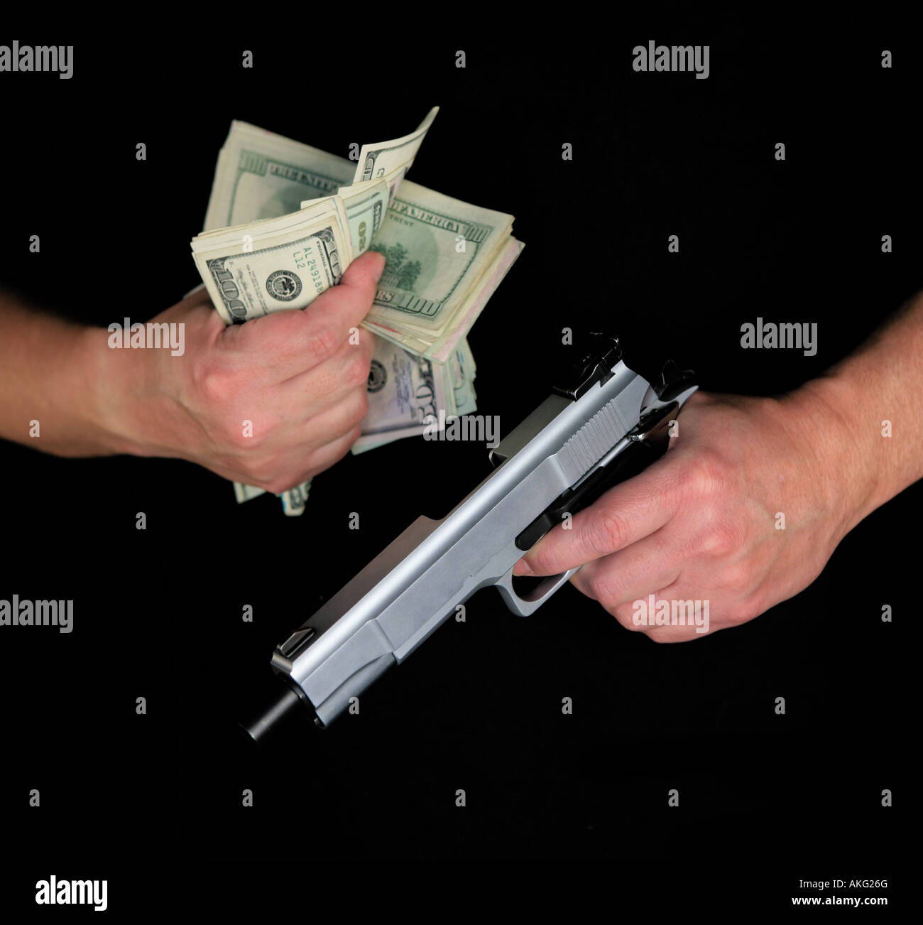 Man in black holding fist full of cash and gun isolated on white background Stock Photo