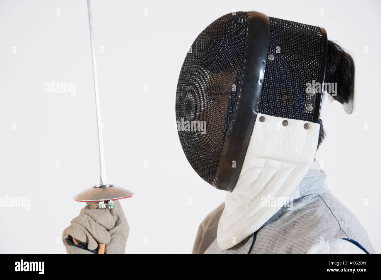 Closeup of a person wearing a fencing mask and holding a fencing foil