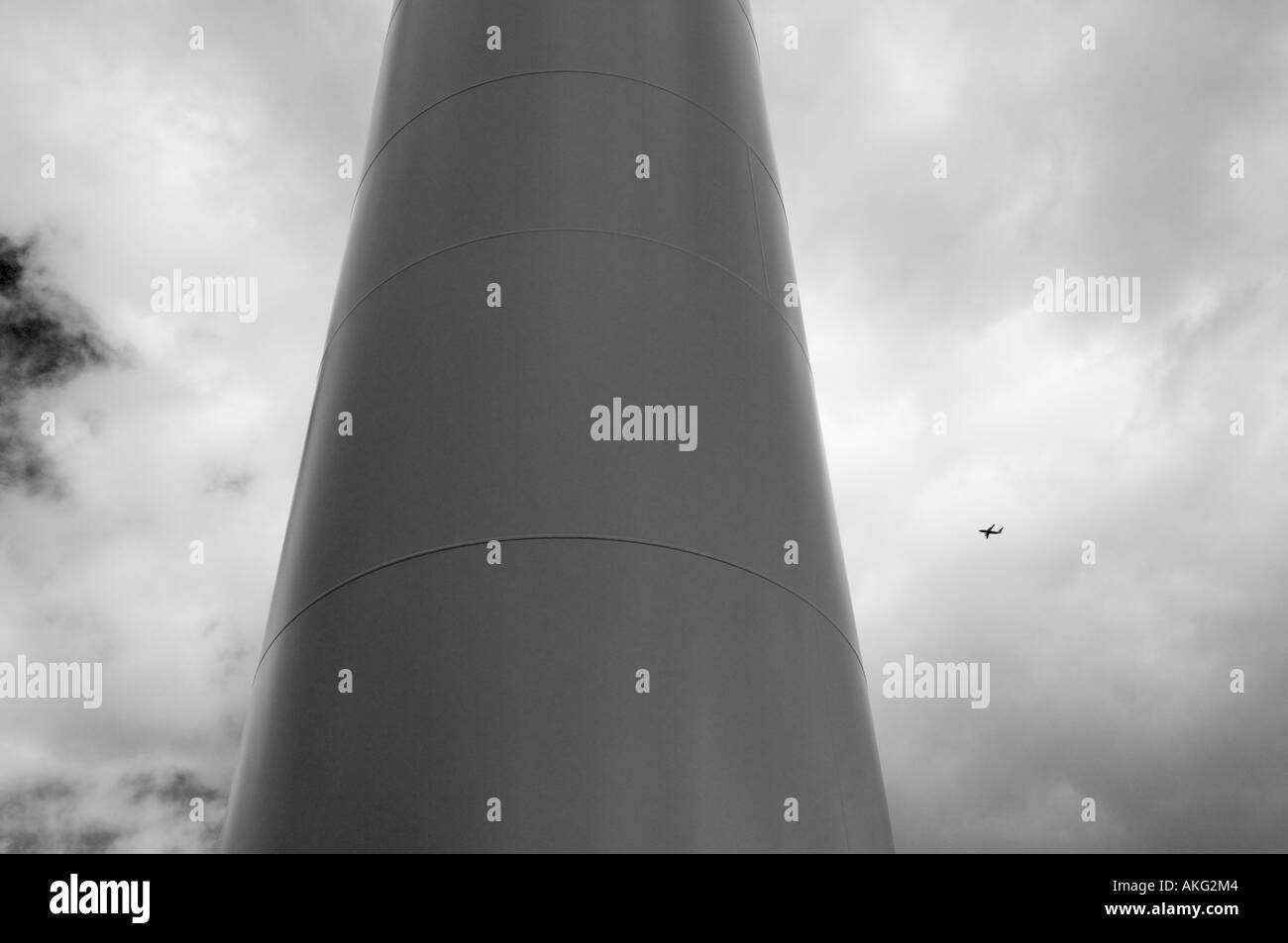 Aircraft flying behind a wind turbine tower, Scotland Stock Photo