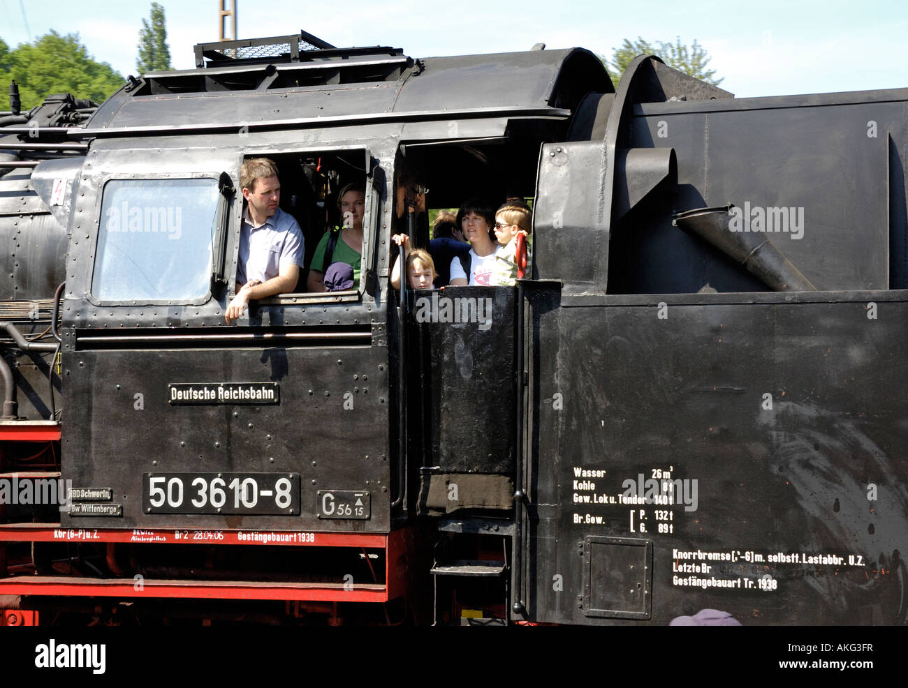 Families enjoying a footplate ride on steam locomotive at Bochum Railway Museum, Germany. Stock Photo