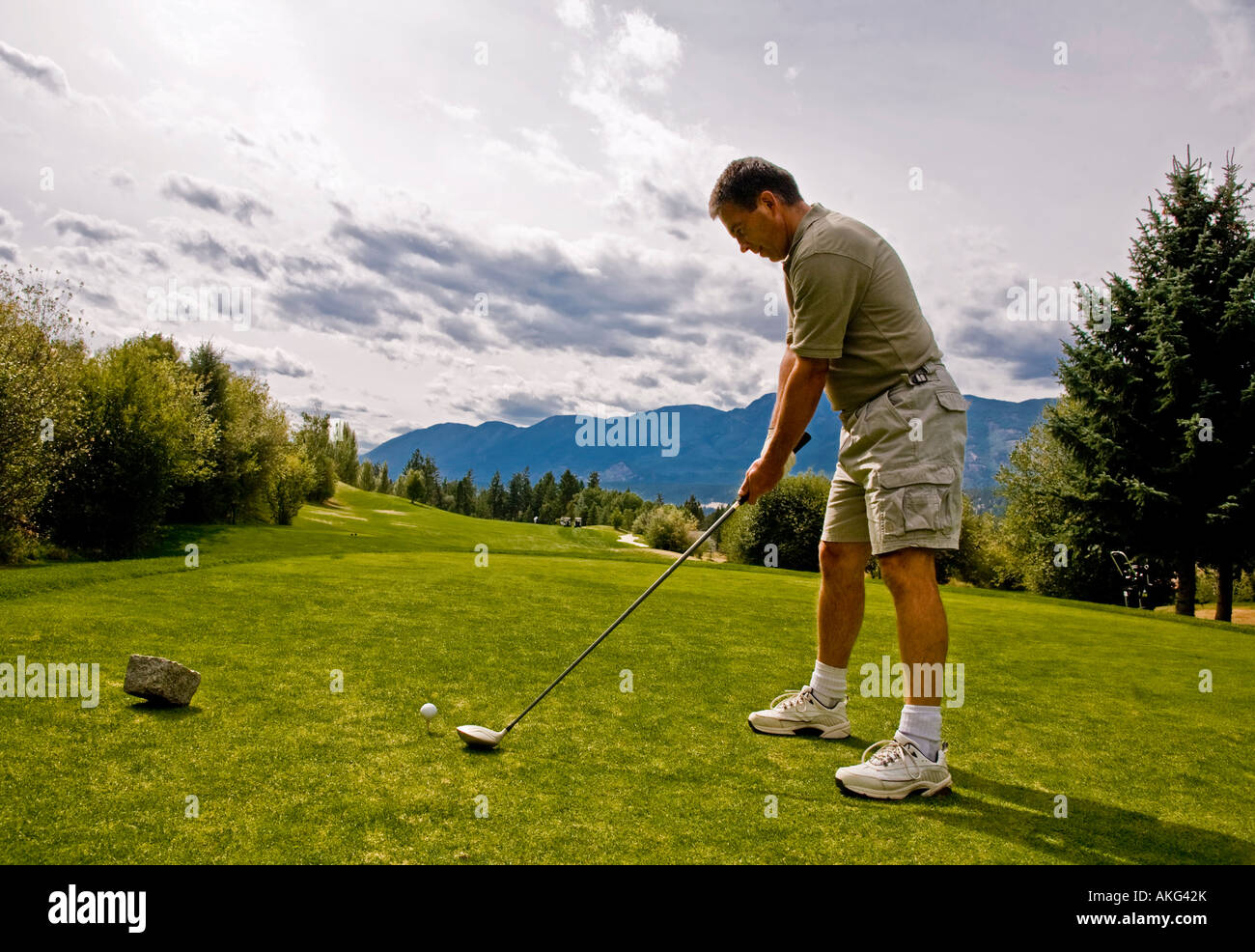 Golfer taking his first shot Stock Photo