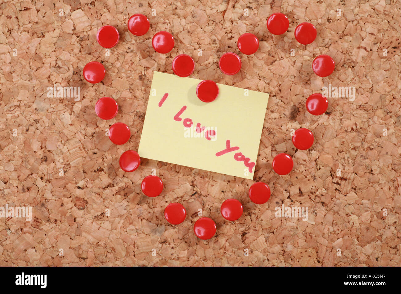 a valentine heart made of thumb tacks on a corkboard Stock Photo