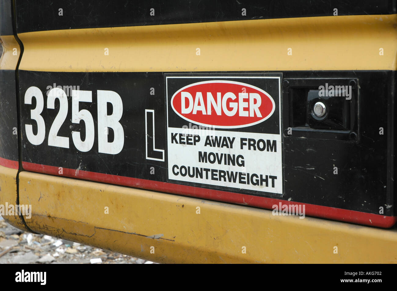 Warning on front end loader many by Caterpillar Tractor Company Stock Photo