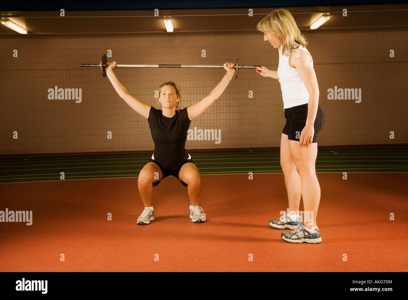 Two women working with weights Stock Photo