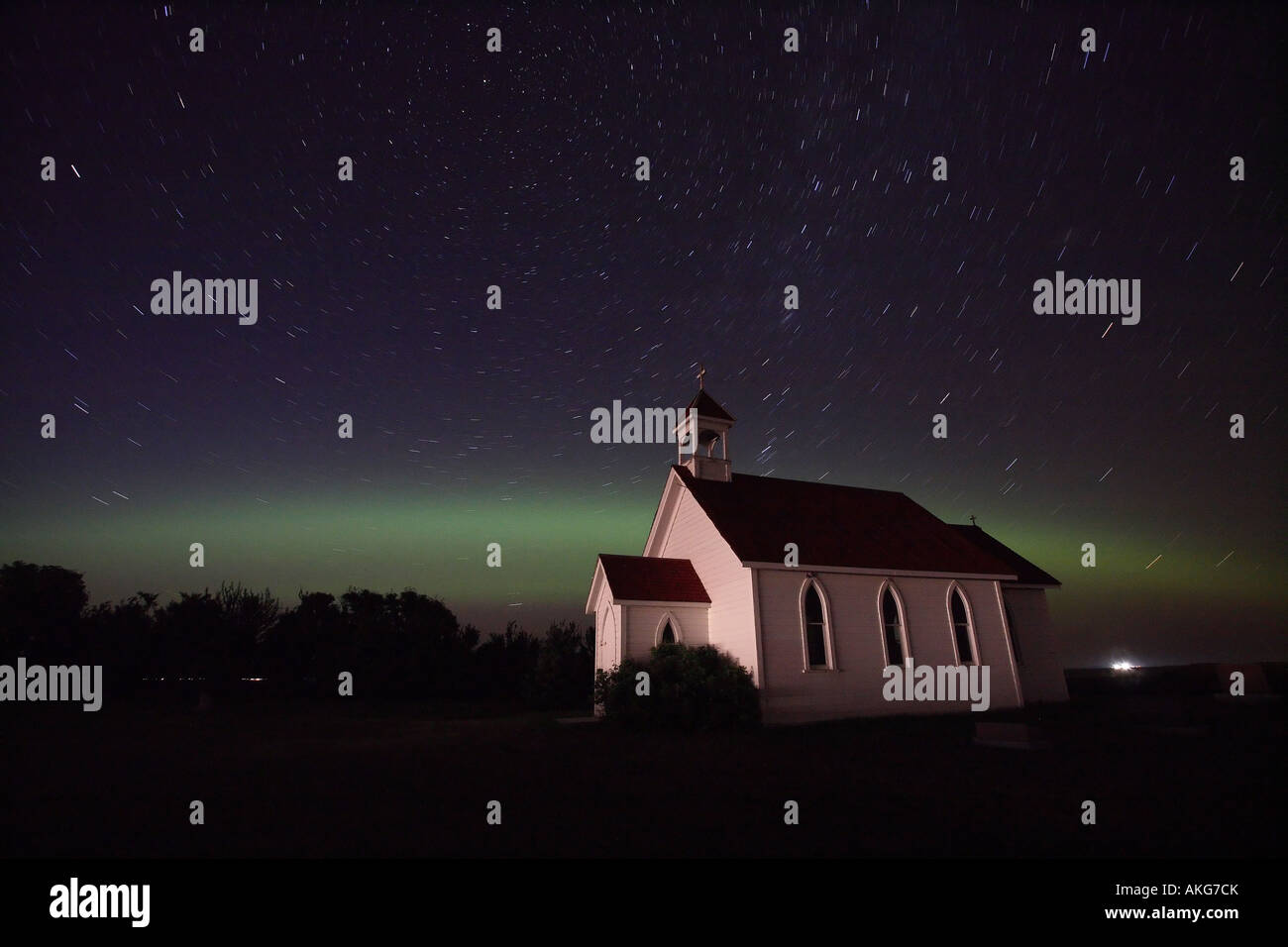 Northern Lights and star tracks over Saint Columba church Stock Photo