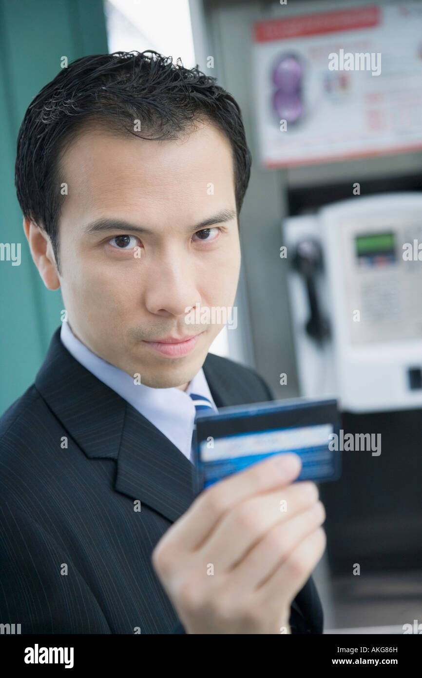 Portrait of a businessman holding a phone card Stock Photo