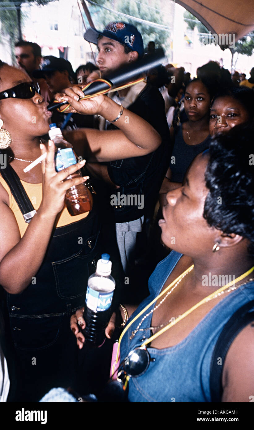 nottinghill carnival with girls dancing and blowing horns in the hip hop tent Stock Photo