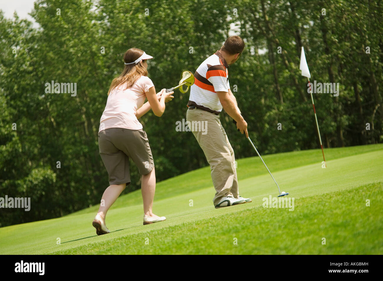 Couple golfing together Stock Photo
