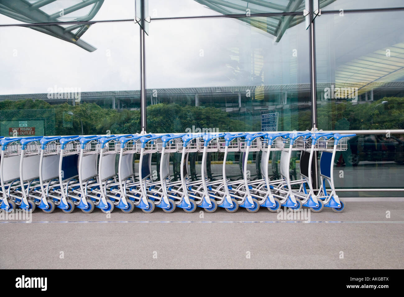 Luggage carts in a row outside an airport Stock Photo