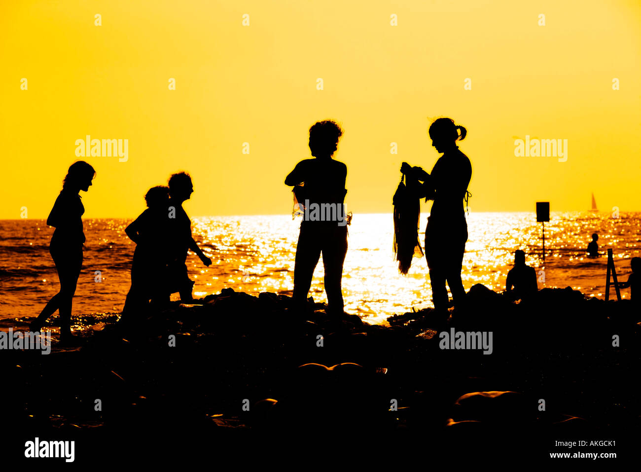 a family on sunset at the beach Stock Photo - Alamy