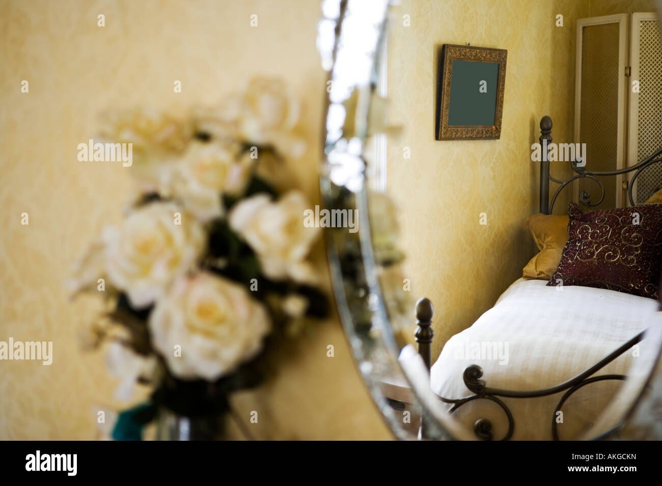 Detail of white roses next to antique vanity mirror. Stock Photo