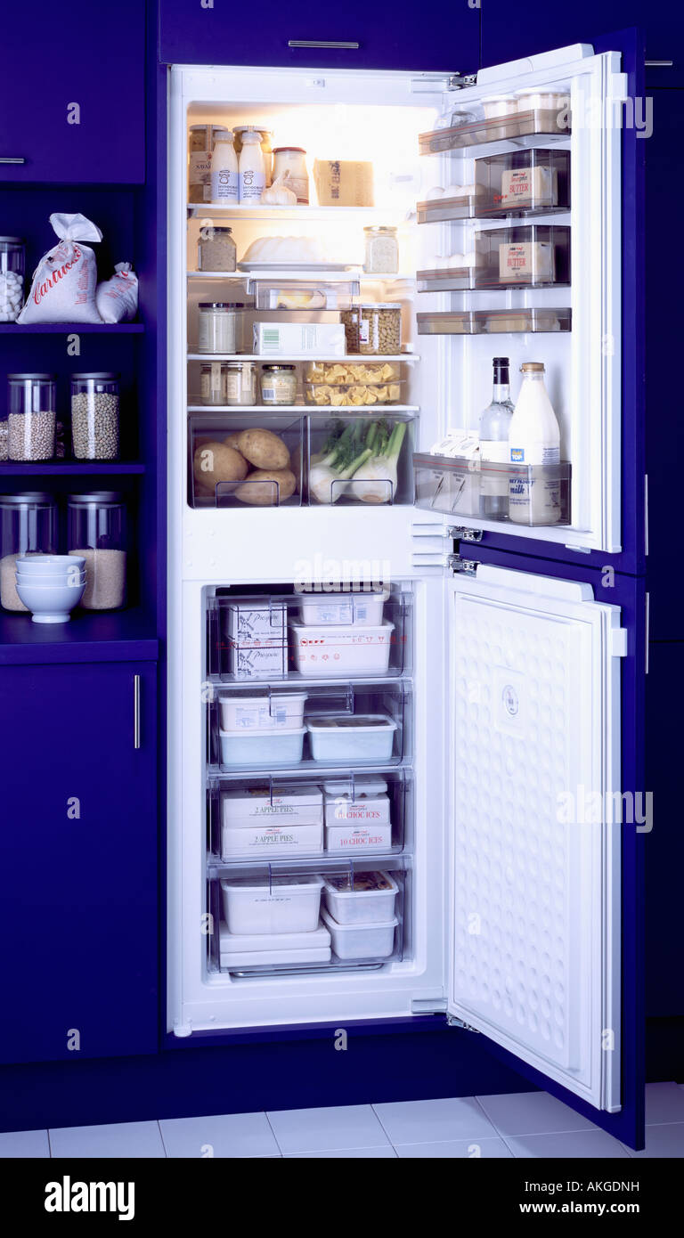 Close up of doors open on fridge freezer in modern blue kitchen