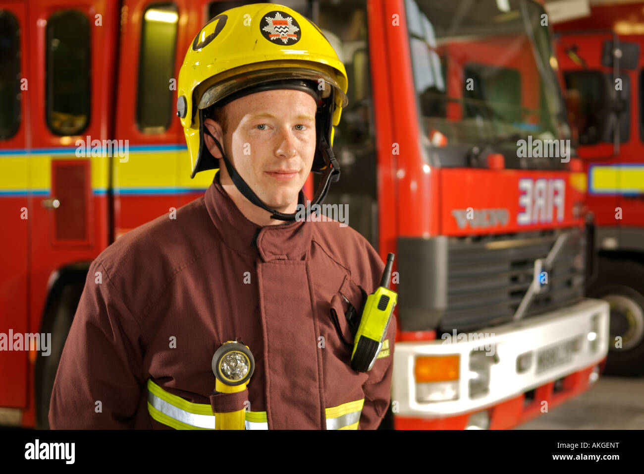 Portrait of London Fire Brigade fireman in front of fire trucks. Stock Photo