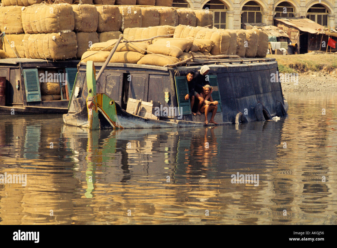 Cotton bales on boat in a Vietnamese canal Stock Photo