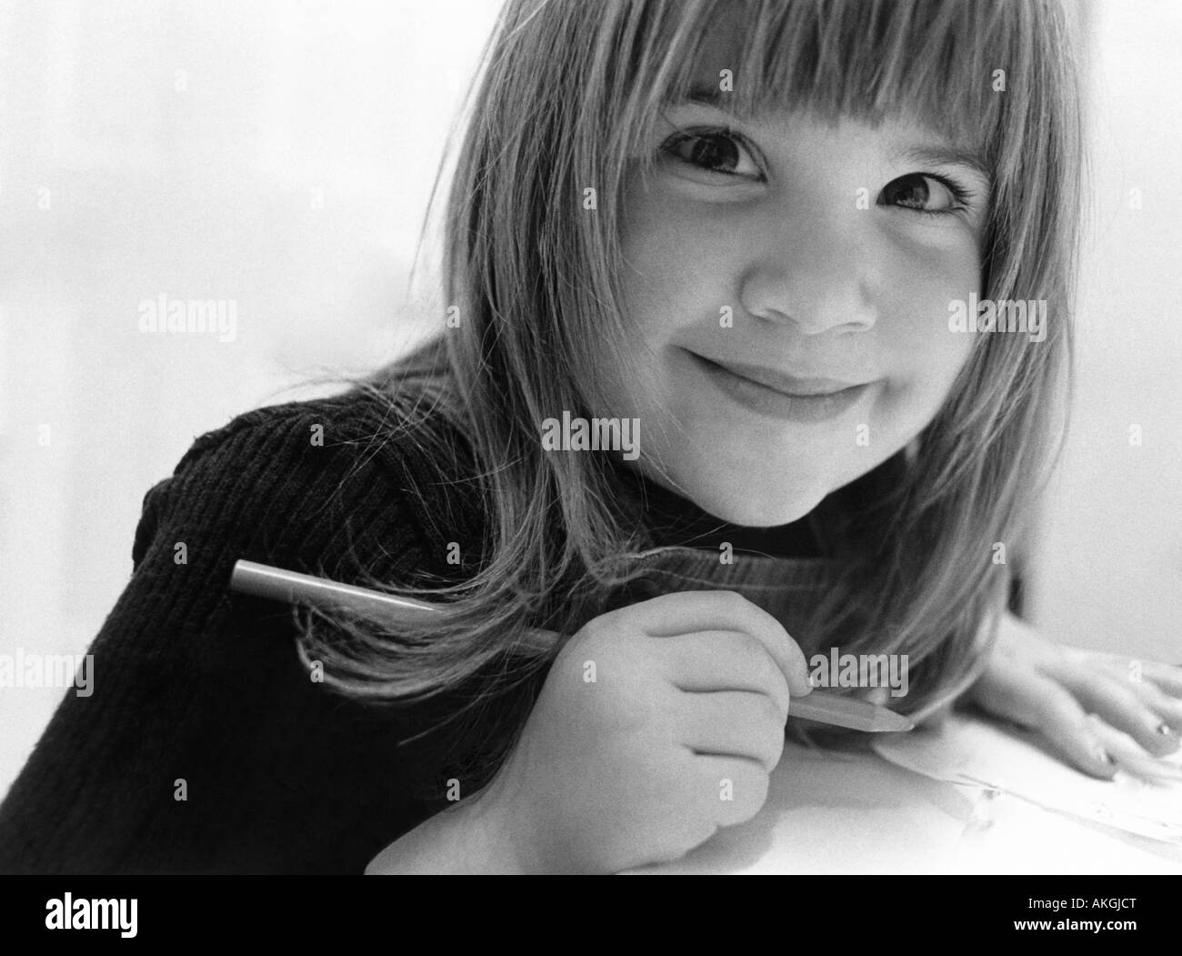 Black and white portrait of daughter writing letter, 1960s. Stock Photo