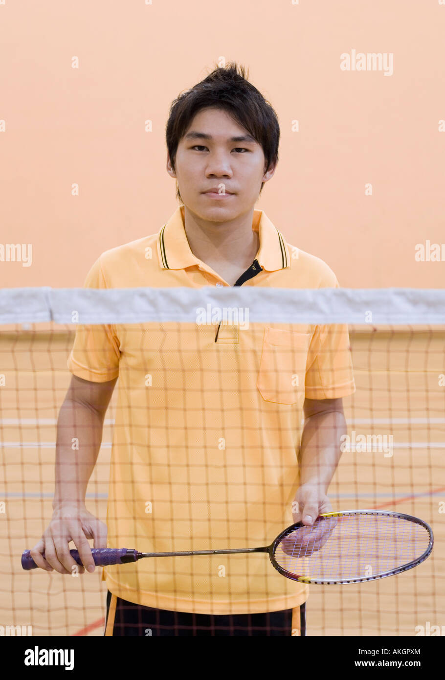 Portrait of a young man holding a badminton racket Stock Photo Alamy