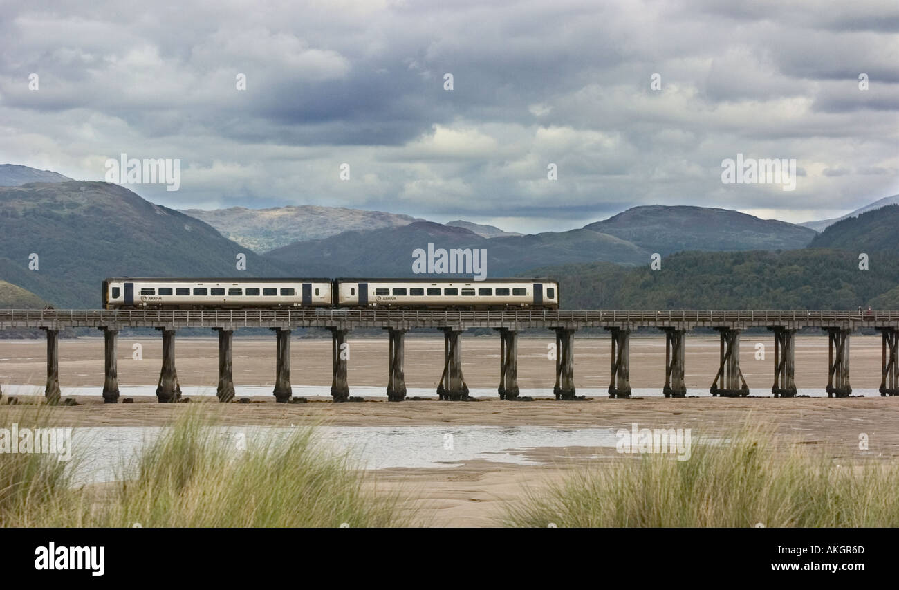 Arriva train crossing River Afon Mawddach at Barmouth in Wales Stock Photo
