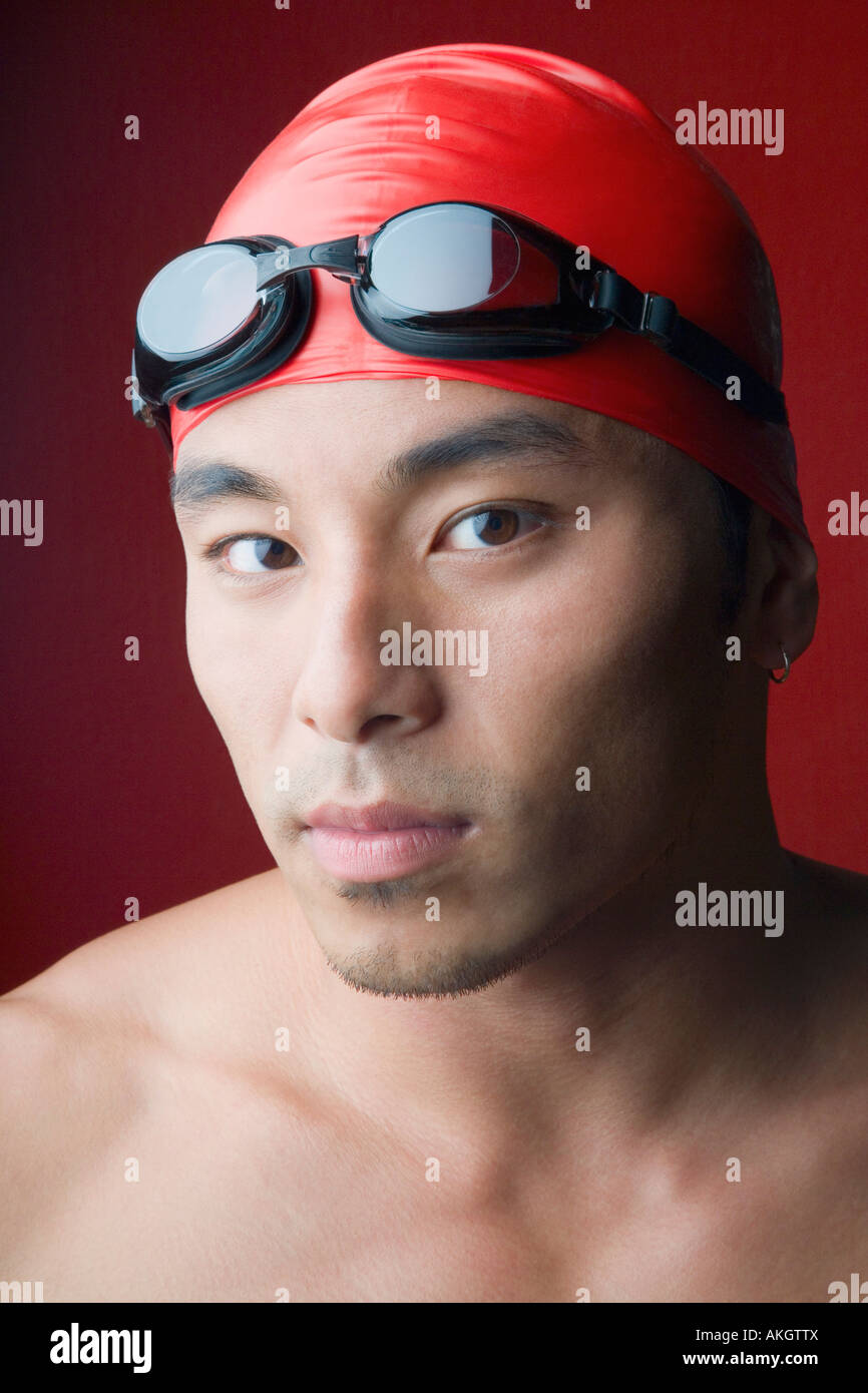 Portrait of a young man wearing a swimming cap Stock Photo Alamy