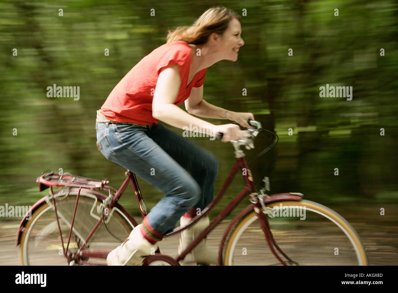 Woman riding fast on bicycle Stock Photo Alamy