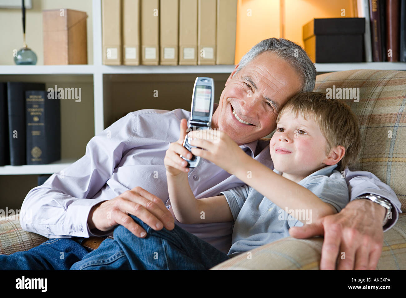 Boy and grandfather with camera phone Stock Photo