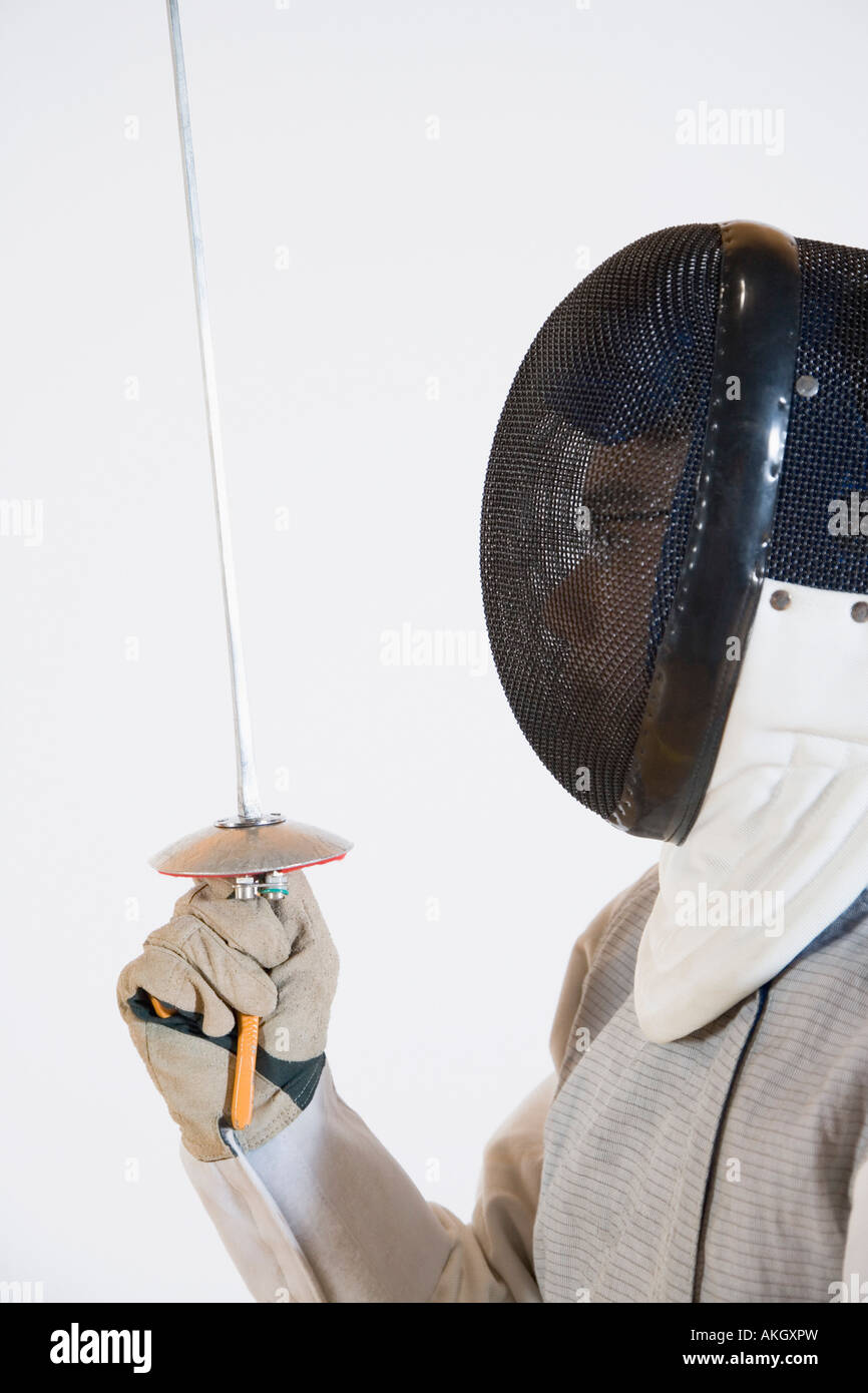 Closeup of a person wearing a fencing mask and holding a fencing foil