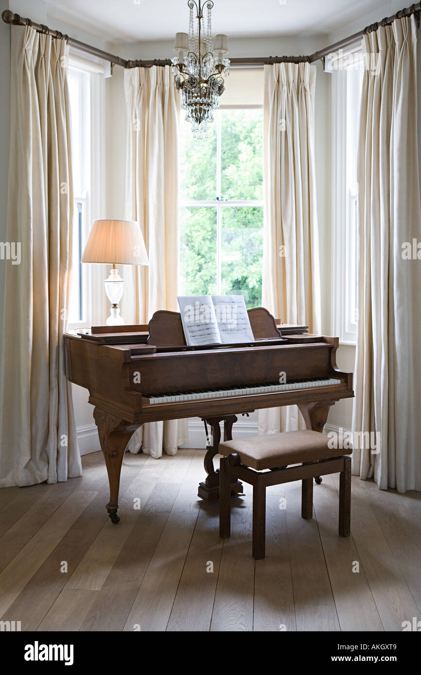 Piano by a window Stock Photo - Alamy